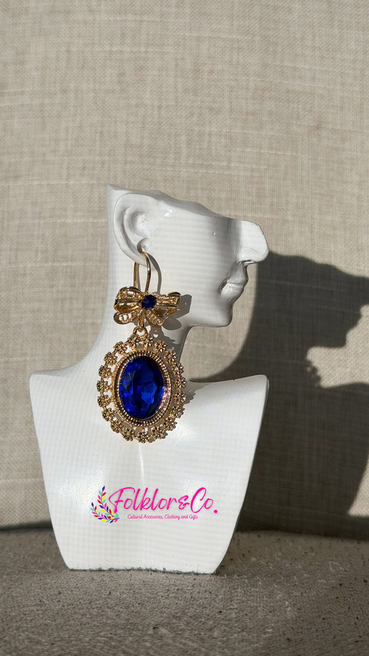 Traditional Mexican filigrana earring on a white mannequin ear with 'Folkloryco’ branding against a beige background