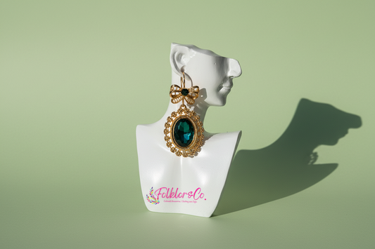 Mexican gold earring with green gemstone on a white mannequin bust with 'Folkloryco' branding.
