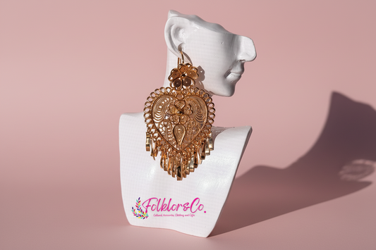 Gold Mexican Folklorico earrings on a white mannequin head with 'Folkloryco.' branding on a pink background