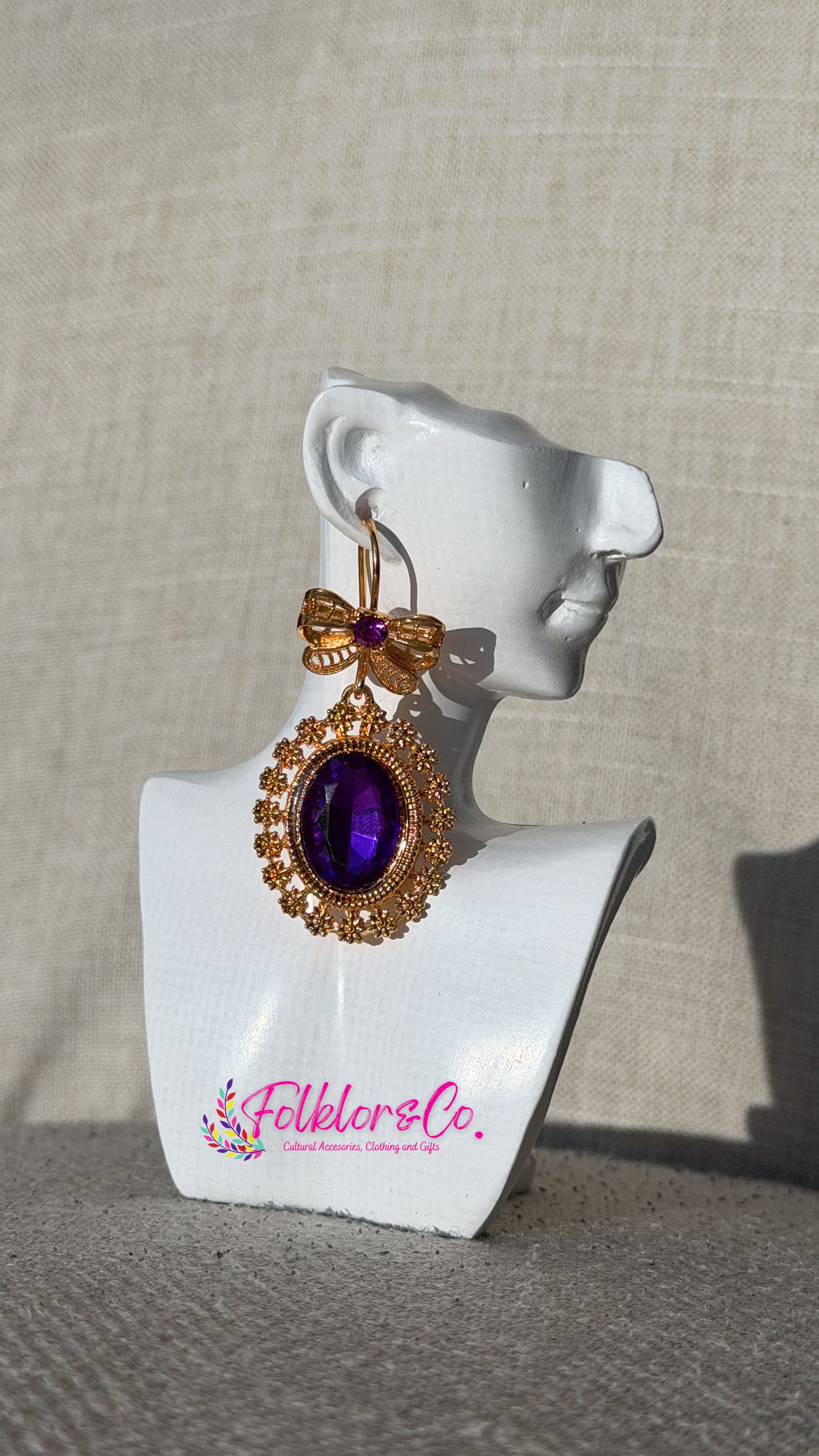 Mexican authentic filigrana purple and gold earrings on a white mannequin bust with 'Folkloryco.' branding.