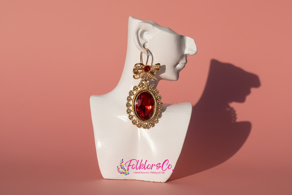 Mexican gold earring with red gemstone on a white mannequin bust with 'Folkloryco' branding.